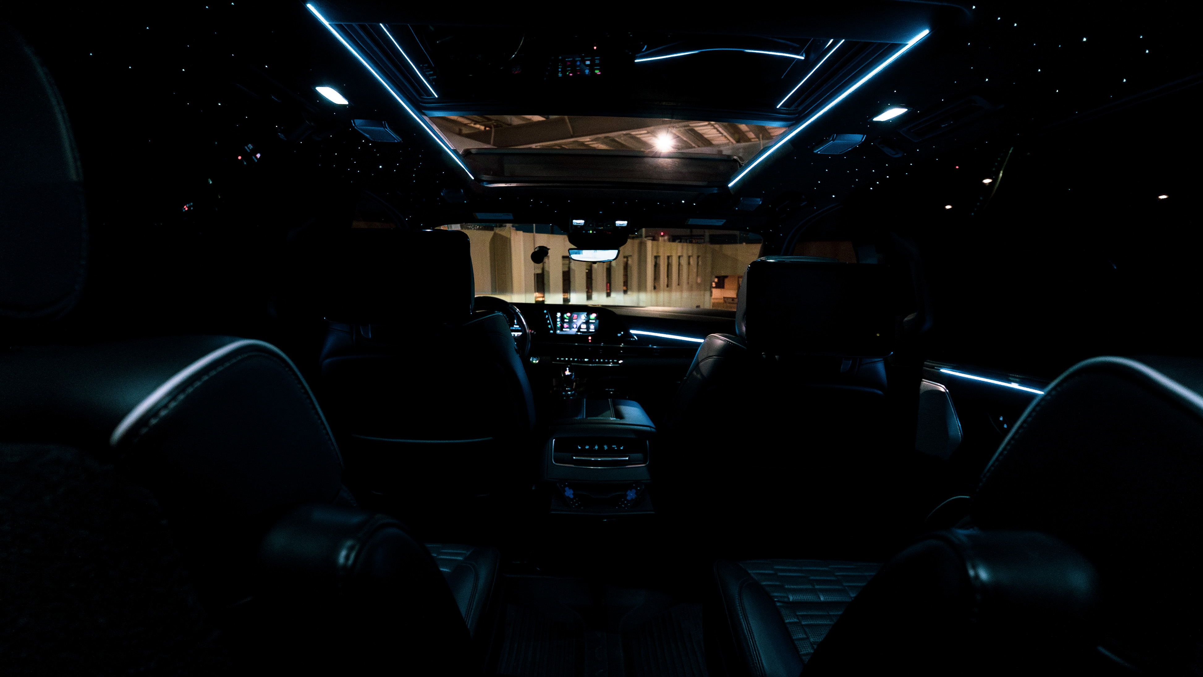 Panoramic view of rear cabin with star ceiling and blue ambient lighting looking forward